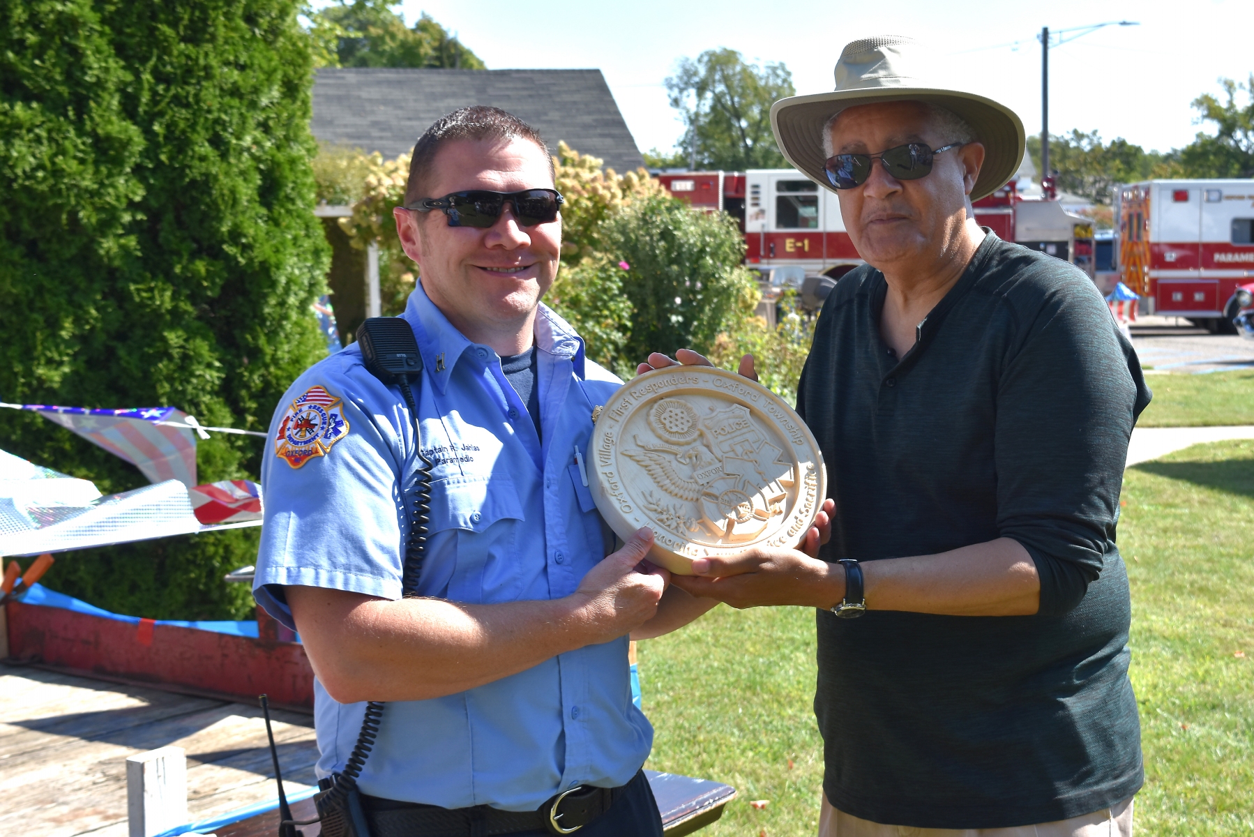 On-behalf-of-Oxford-Fire-Department-Cpt.-Ron-Jahlas-accepts-an-engraved-plaque-from-Oxford-UMC-pastor-Julius-E.-Del-Pino.-Photo-by-J.-Hanlon.