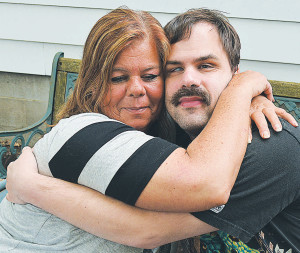 Oxford Village residents Deborah and Tim Brown share a hug Saturday as a whole laundry list of improvements was made to their Lincoln St. home. The mother and son were quite overwhelmed by it all.