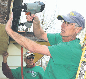 CIA volunteers Chuck Martus (front), of Oxford, and Owen DuVall, of Beverly Hills, Michigan, work on the exterior of Bonnie Davis’ home. Photo by C.J. Carnacchio.