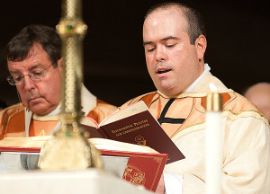 Newly-ordained Fr. Paul Graney reads the prayers during the liturgy of the Eucharist.