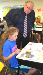 State Supt. Brian Whiston looks over the work of Oxford Elementary third-grader Tristan Krajcarski. Photo by Elise Shire.