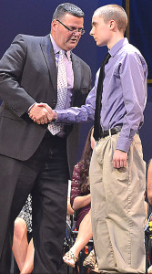 OHS Principal Todd Dunckley (left) congratulates Charles Devlin, who graduated last week, on one of his numerous awards and scholarships. Photo by Elise Shire.