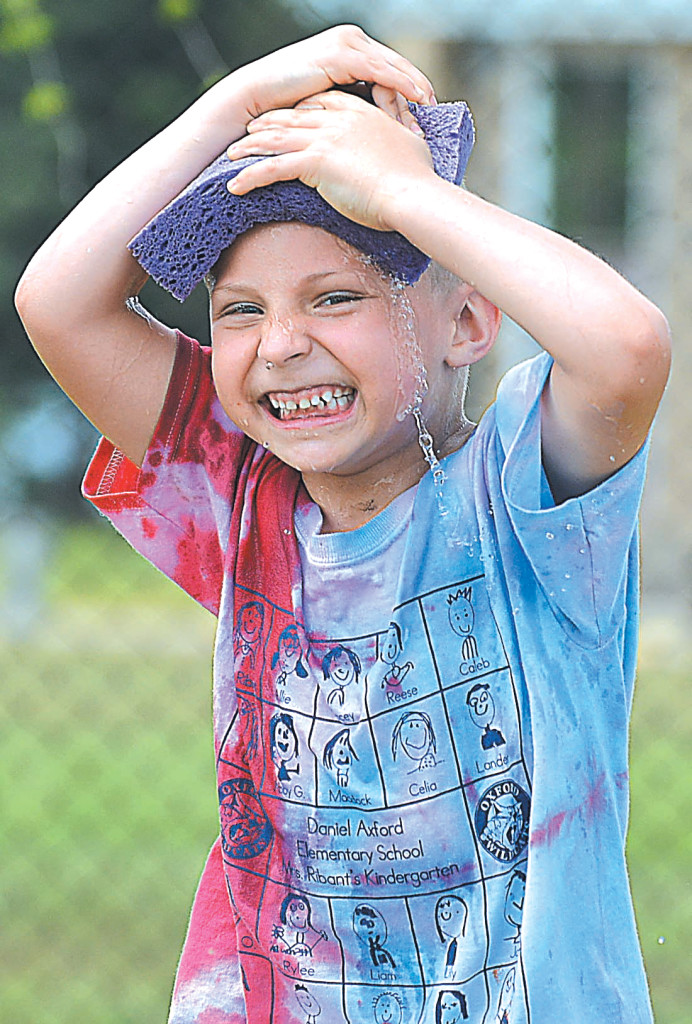 Kindergartner Charlie Sproul finds the perfect way to cool off on a hot day.