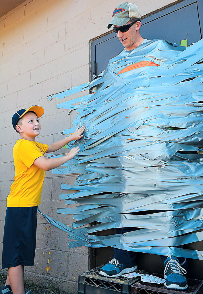 Isn't it every kid's dream to duct tape their principal to the wall? David Swoish (left) got to do just that to OES Principal Jeff Brown. Did anyone remember to take him down?