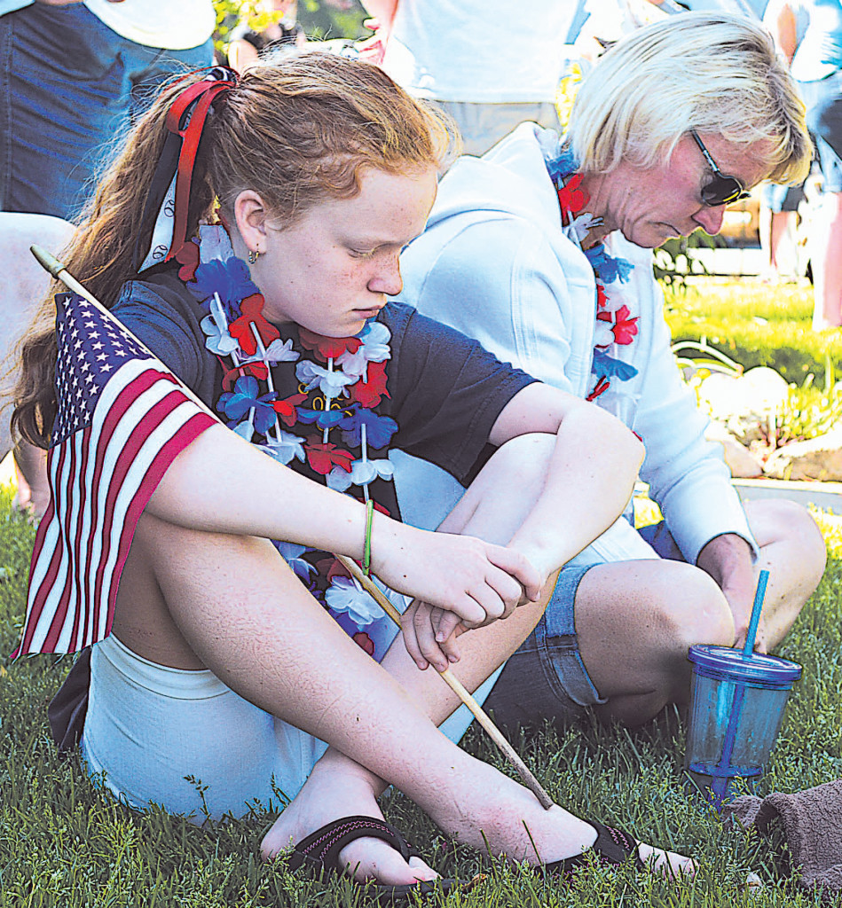 Bowing their heads during a moment of prayer are Oxford residents Kaylee (left) and Kim Misialek. Kaylee is a fifth-gader at Clear Lake Elementary.