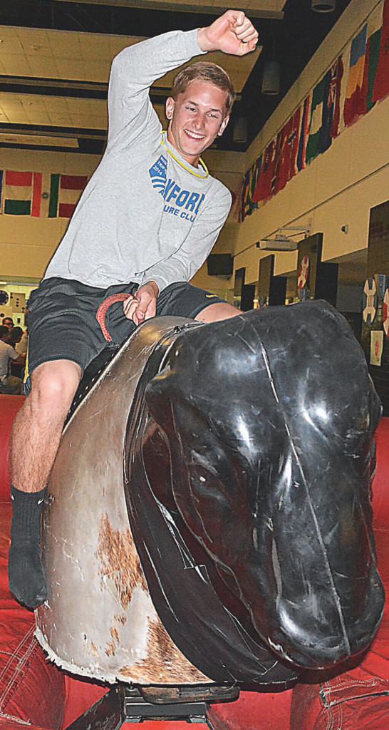 Anson Rowley rides the mechanical bull with gusto.