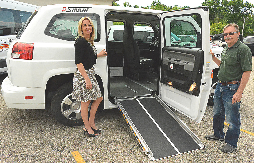 Lynn Gustafson (left), director of the North Oakland Transportation Authority, and Doug Noaker, NOTA's operations manager, show off the new MV-1's power ramp, which makes it easily accessible for riders in wheelchairs. Photo by C.J. Carnacchio.