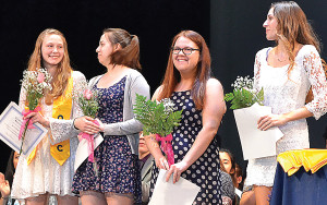 OHS seniors Kristen Ewald (from left), Serafina Tenaglia, Sondra Deloy and Sydney Hill stand proudly with roses and awards. All four seniors were awarded the Pay it Forward scholarship last week. Photo by Elise Shire.