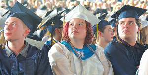 Watching a video during the commencement ceremony are graduates Jacob Bossingham, Marielle Bose-Moody and Jacob Bose-Moody. Photo by C.J. Carnacchio.