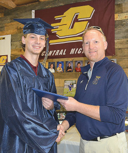 Fisher Stuk, a 2016 graduate of Oxford High School, receives his diploma from Superintendent Tim Throne. Throne went to Stuk's home on Saturday to present it since he missed the commencement ceremony due to a medical emergency. Photo by C.J. Carnacchio.