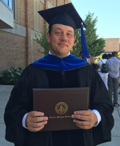 Gregg Dionne, a 1993 OHS grad, holds his doctorate following his graduation.