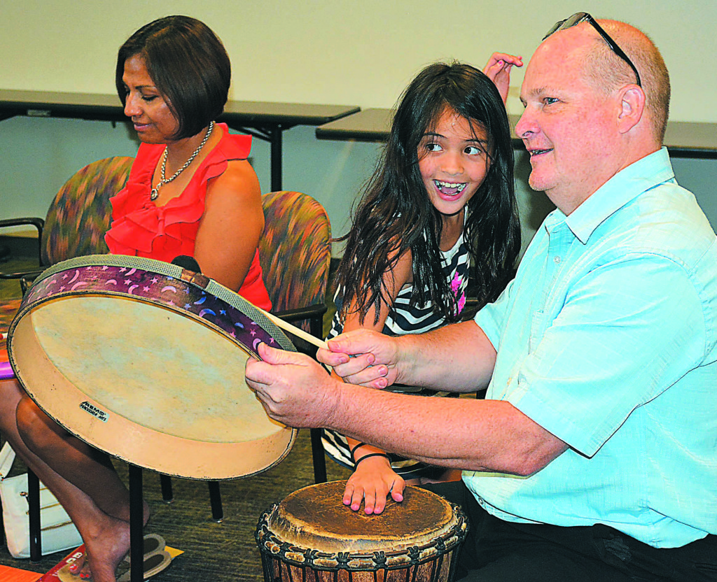 Oxford resident Mark Lee had a good time playing the drums with his daughter Dana, 8. Behind them is Mark's wife, Marciela. Photo by C.J. Carnacchio.