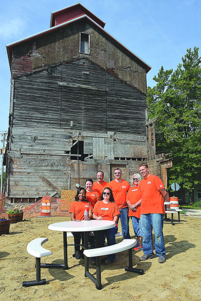 Home Depot employees pose for a photo after finishing the job. Pictured are: Shatia Belcher (seated), Terri Decaussin (seated), Alana Hart, Fred Bruno, Matt Goldsworthy, Lisa Thompson, and John Okar. Photo by C.J. Carnacchio.