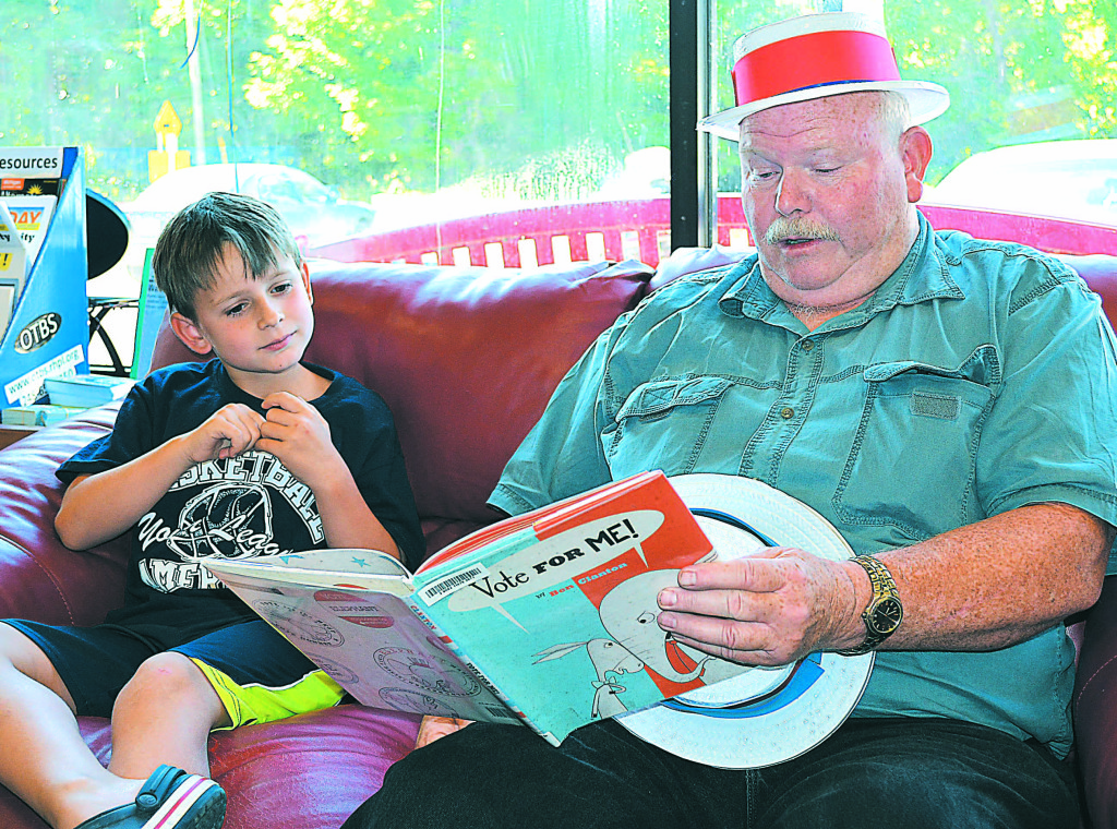 Bruce Pearson reads to Max Bican, a second-grader at Leonard Elementary. Photo by C.J. Carnacchio.