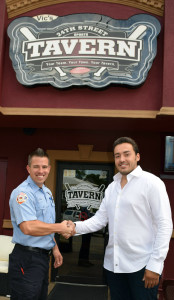 Oxford firefighter Kevin Snell (left) and Lindon Palushaj, co-owner of the 24th Street Sports Tavern, are teaming up to keep local children safe. Photo by Elise Shire.