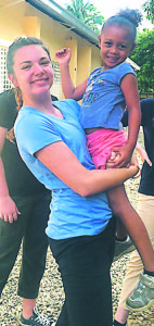 Tate Hamilton, of Oxford, with one of the Dominican children she met during her trip to the Caribbean nation.