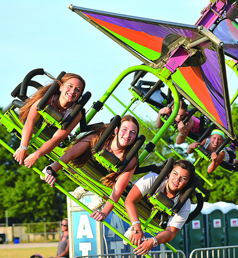 Oxford High School sophomores (from left) Chloe Allen, Ana Raab, and Kayla Hung take flight on the hang-glider ride.