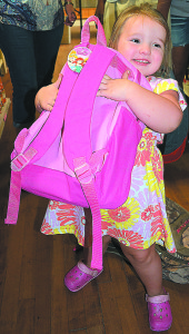 Sophiea, 3, of Lake Orion, is so happy with her new backpack. Photo by C.J. Carnacchio.