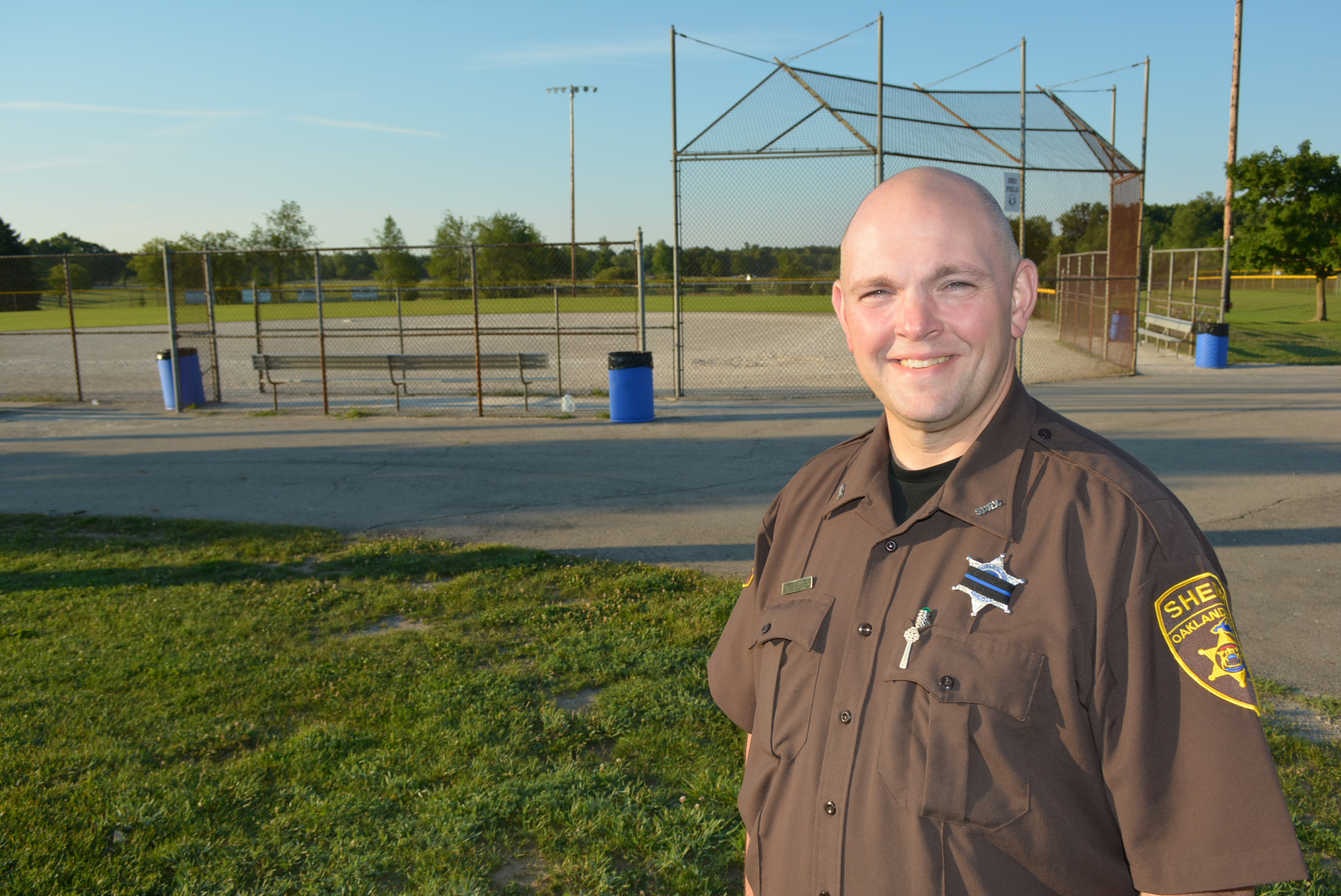 Oakland County Sheriff's deputy Mark Chevalier is inviting the public to the Bars vs. Cars charity softball game at Seymour Lake Township Park in Oxford. Photo by C.J. Carnacchio.
