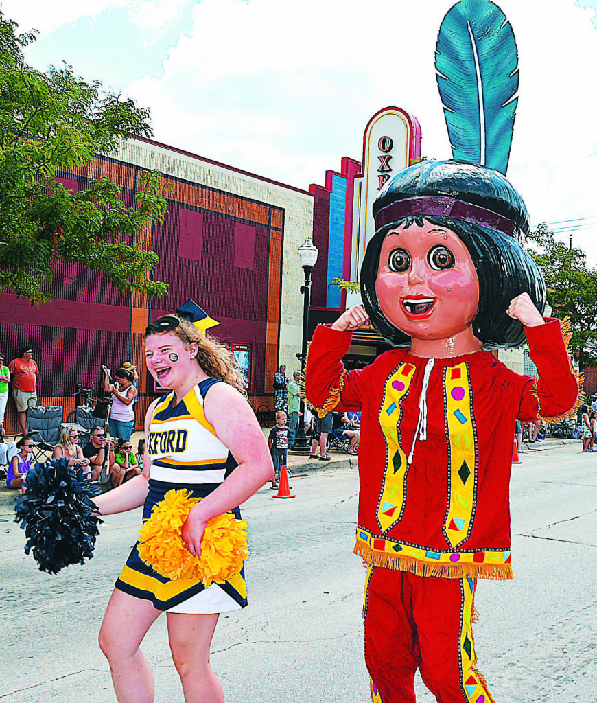 Oxford High School cheerleader Ashley Zyrowski escorted this strong, young Indian brave through downtown Oxford.