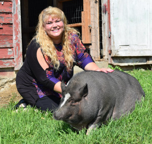 Heather Lepping, of Oxford, with Meatball, her potbellied pig that inspired her adult coloring book. Photo by Elise Shire.