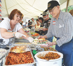 WWII veteran Otto John Jones, of Oxford, gets his plate filled at last year's picnic.