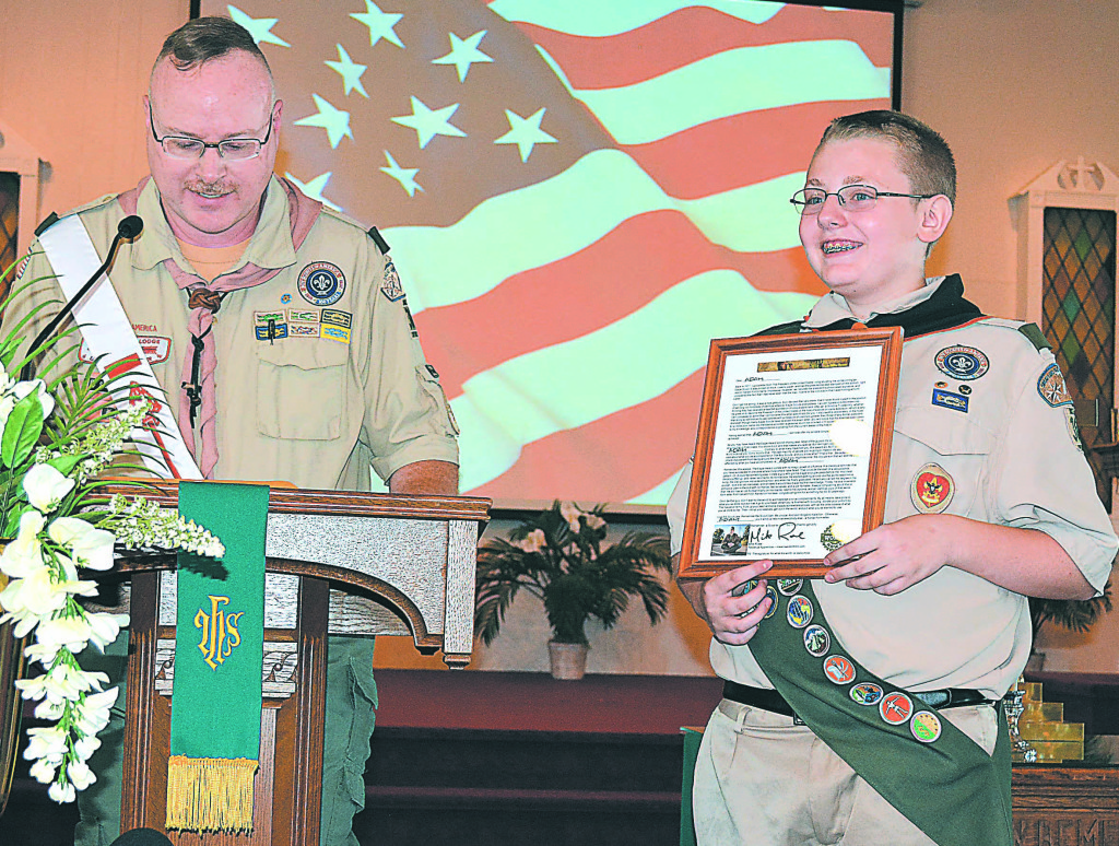 Eagle Scout Adam Bertich (right) holds the letter he received from Mike Rowe, host of the Discovery Channel's "Dirty Jobs." Troop 366 Assistant Scoutmaster Steve Patterson read the letter to the audience during the Court of Honor ceremony. Photo by C.J. Carnacchio.