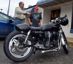 John Boehmer, of Leonard, shows off his motorcycle and chats with James Elsarelli (right). The 1978 Honda CB750F was the sole entry in this year's car/motorcycle show.