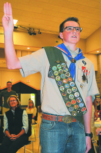 Rory Boes raises his right hand and recites the Eagle Scout Oath during his Court of Honor ceremony held Saturday at Christ the King Church. Photo by C.J. Carnacchio.