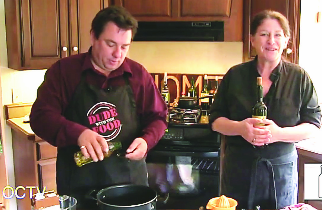 Connie Miller (right), host of "Connie's Kitchen" on OCTV, chats with viewers as her husband, Oxford Leader Editor C.J. Carnacchio, pours some olive oil during the episode that will be recognized with an award at the Philo Festival of Media Arts Oct. 28.