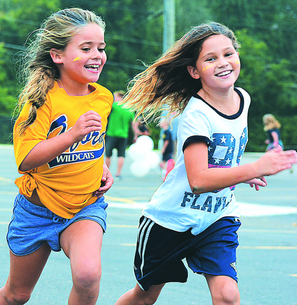 Gabby Green and Jaidan Rivers ran round and round with big smiles on their faces. Photo by C.J. Carnacchio.