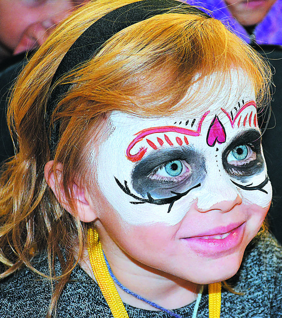 London Brewer, 4, of Oxford, admires her new paint job in the mirror.