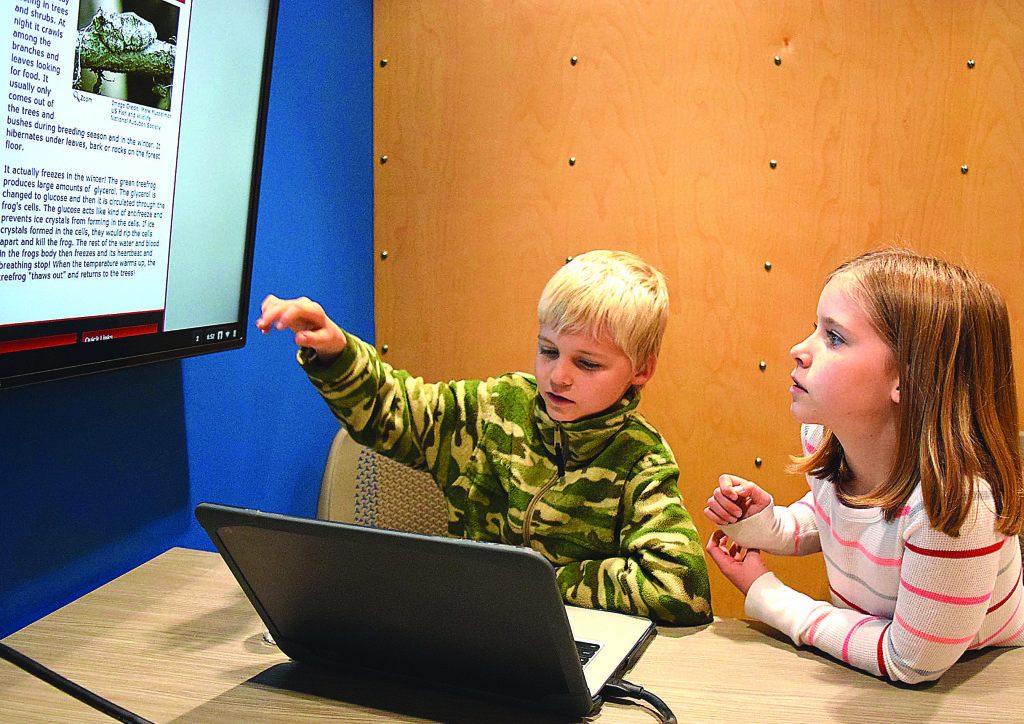 Joseph Bryson and Grace Jubelt test out some of the technology at the Oxford Virtual Academy's new Elementary Learning Center.