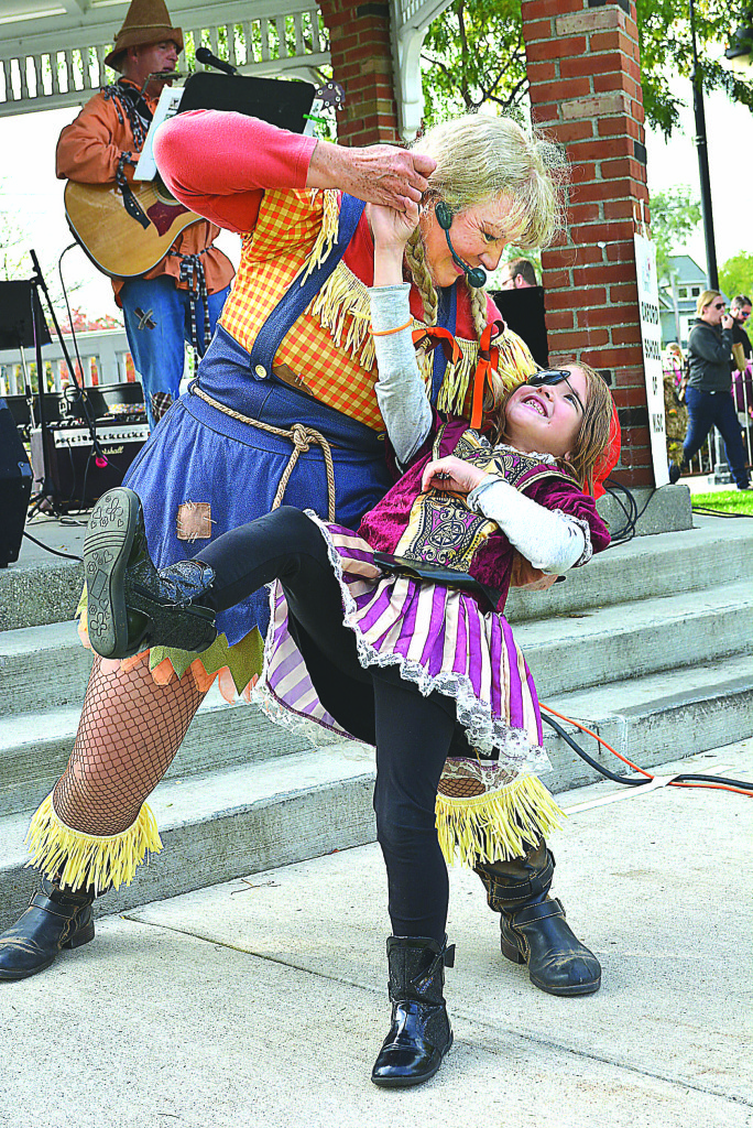 Little pirate Celine Frank, 7,  of Oxford, gets dipped by Suzanne MacDermid, of the musical duo Balancing Earth.