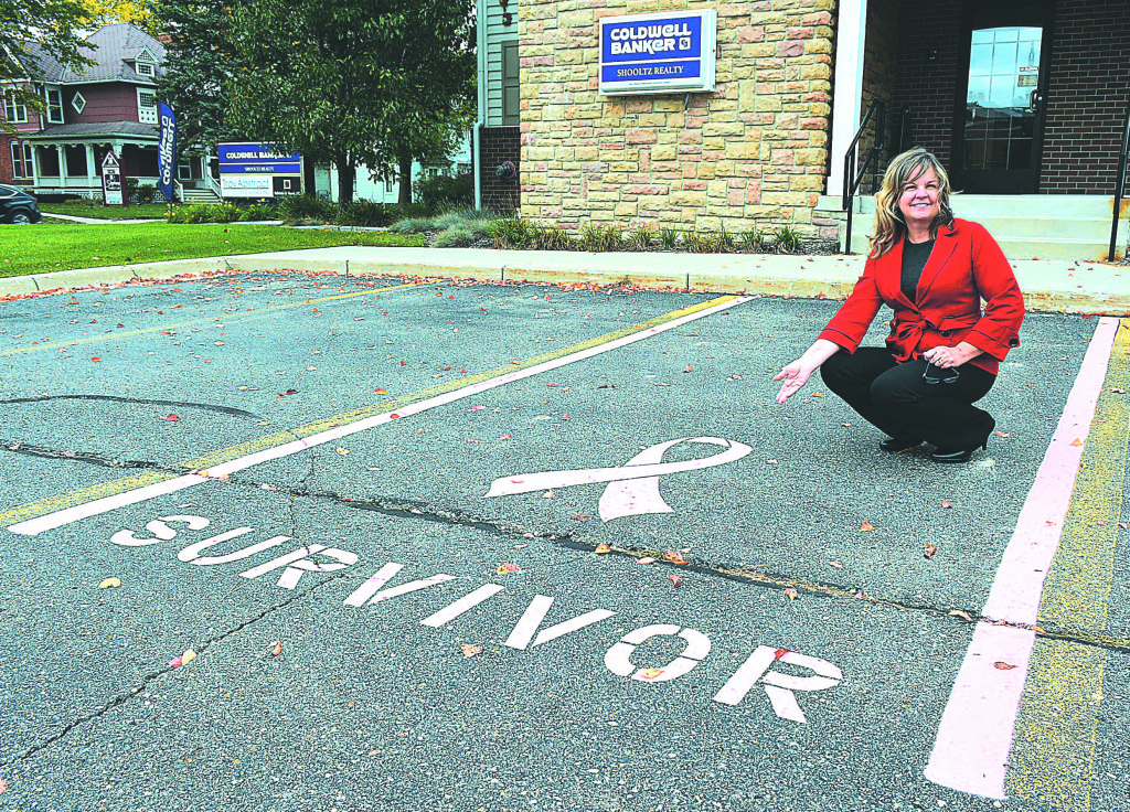 Mary Matthews, managing broker at Coldwell Banker Shooltz Realty in Oxford, shows off the firm's new designated parking space for breast cancer survivors. Anyone who has been diagnosed with the disease, no matter where they are in their battle, is welcome to park there. Photo by C.J. Carnacchio.