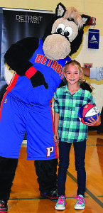 Clear Lake third-grader Camryn Quidort won the jumping jack contest and was given a basketball by Detroit Pistons mascot Hooper. Photo by Elise Shire.
