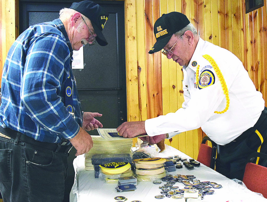 Pontiac resident and Vietnam-era vet Ronald Helm (left) receives his lapel pin from Mike Hardy, third state commander of the American Legion.