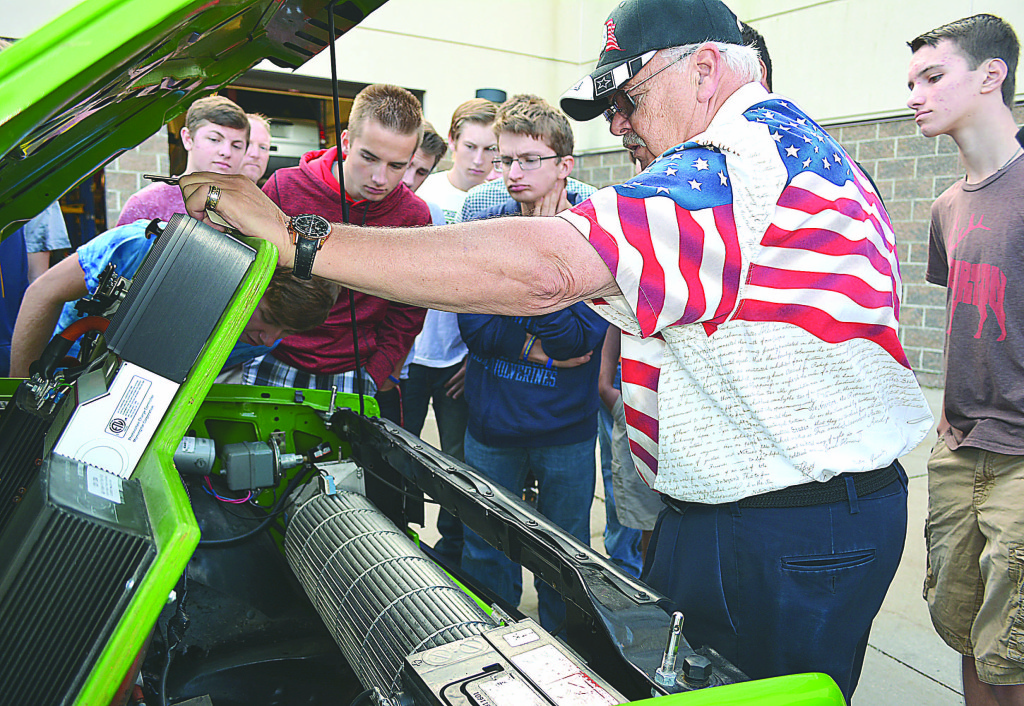 Warnke shows students (from left) Noah Resst, Mike McConough, Dylan Troutt, Josh Currie, and Hudson Butler what's under the hood. That cylinder is the squirrel cage fan. Photo by C.J. Carnacchio.
