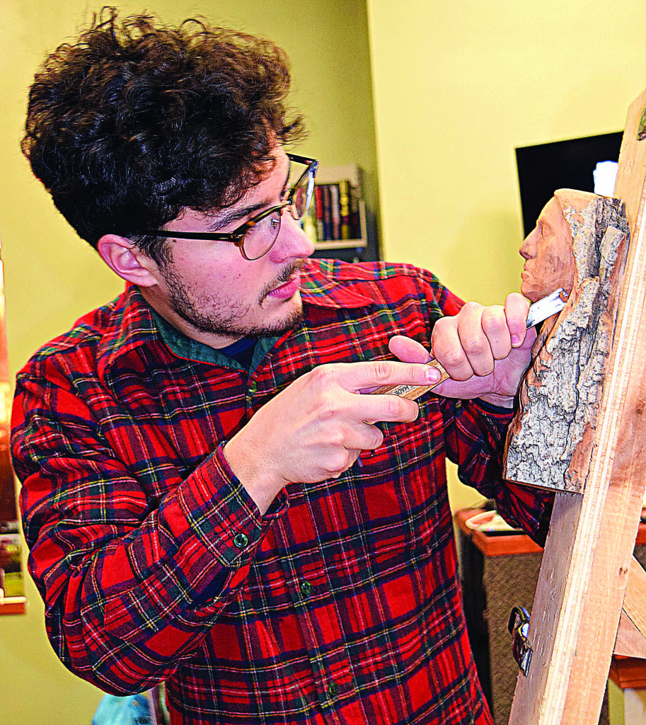 Wood sculptor Alec LaCasse, of Addison Township, demonstrates his talents at the Addison Township Public Library. Photo by Elise Shire.