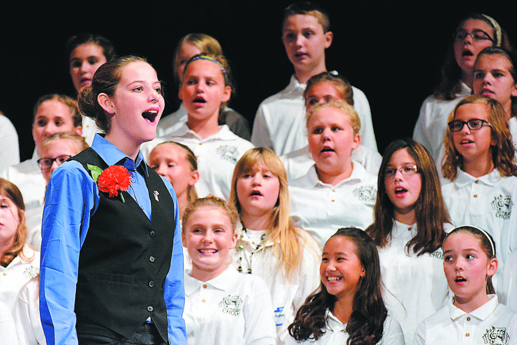 Eighth-grader Jordan Goik performs "This is My Homeland" with sixth-graders. Photo by C.J. Carnacchio.