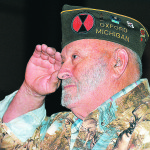 Bob Woodcum, a U.S. Army veteran, salutes with pride.