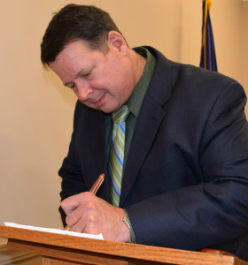 Newly-elected Addison Trustee Joel King signs some paperwork. Photos by Elise Shire.