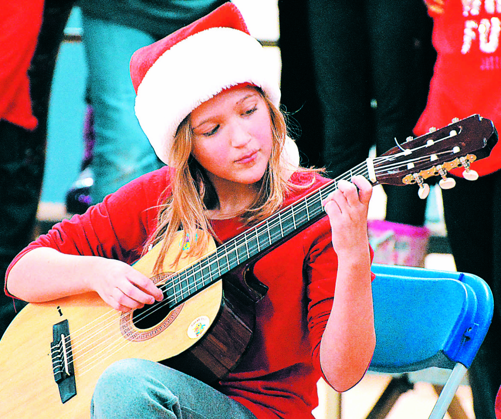 Clear Lake student Allison Hepp plays Christmas tunes on her guitar. Photos by C.J. Carnacchio.