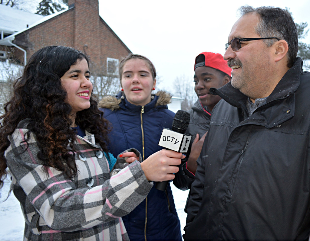Crossroads resident Diyana (far left) interviews Detroit Pistons Coach Stan Van Gundy for Oxford Community Television. Watching in the background are fellow Crossroads residents Jessica (left) and Keylen. Photos by C.J. Carnacchio.