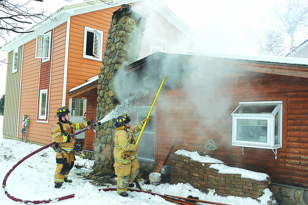 Oxford firefighters battled a house fire on Maloney Ave. late Tuesday morning. Photo by C.J. Carnacchio.