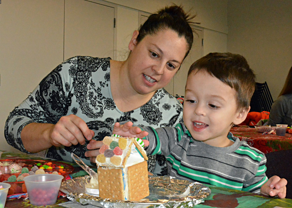 Emily D’Angelo and her son, Felix, 3, build a gingerbread house together. Photos by C.J. Carnacchio.