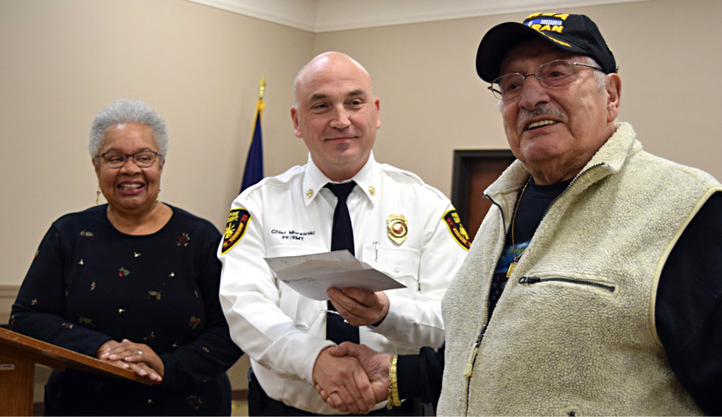 Geno Mallia, Sr. (right) presents a $14,700 check to Fire Chief Jerry Morawski (center). Looking on is former Lakeville UMC Pastor Jacque Hodges. Photo by Elise Shire.