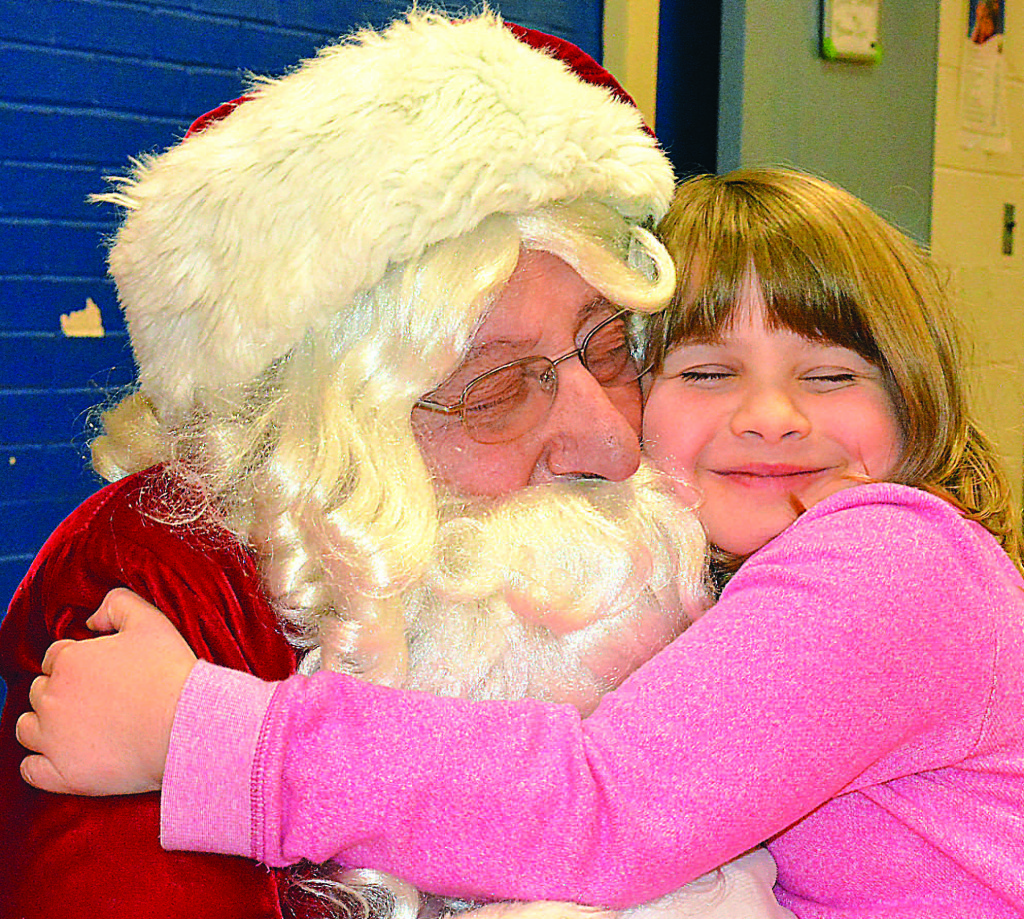 Leonard student Annabelle Meldrum gives Santa Claus a great, big warm hug.