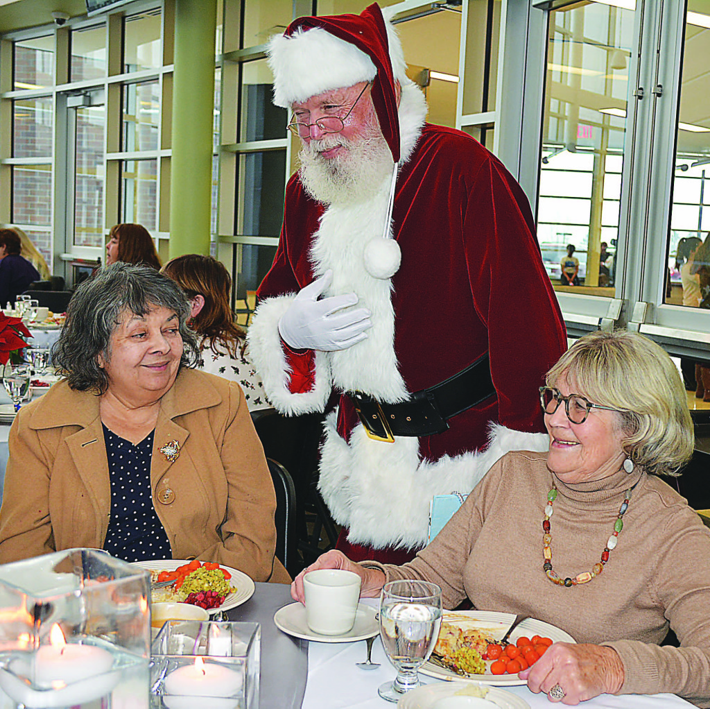 Jolly Old Saint Nick visits with Oxford resident Donna Sheach (right) and Dilly Todahl, also of Oxford. Photo by C.J. Carnacchio.