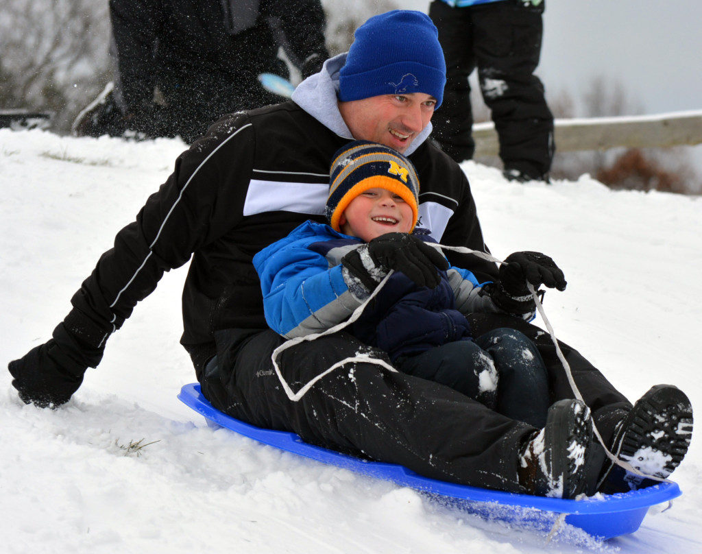 Oxford residents Eric  Raab and his son Will, 5, enjoyed sledding down the big hill at Seymour Lake Twp. Park. Photo by CJC.